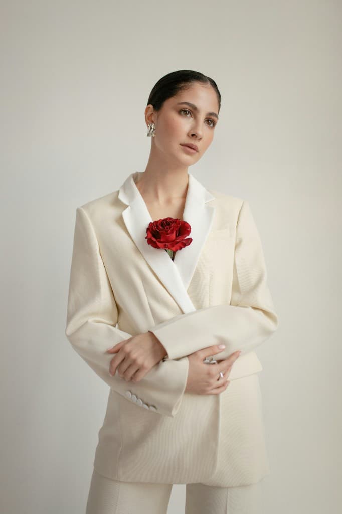 Cream blazer fashion editorial on gray background