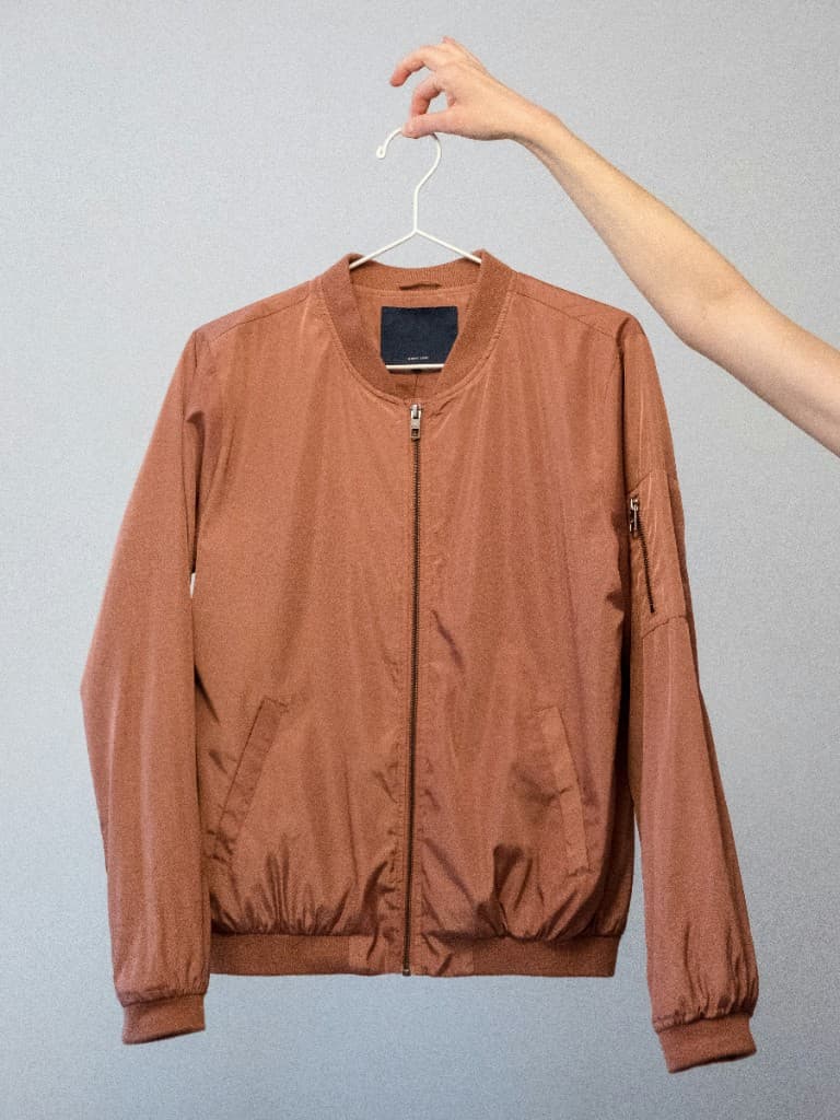 Terracotta bomber jacket on a gray background